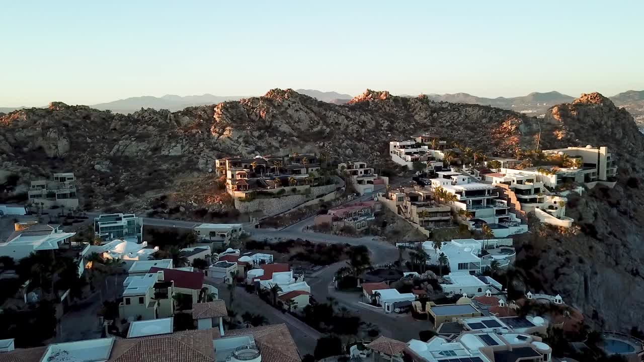 Cabo San Lucas residential area with beautiful houses on hills. Aerial forward