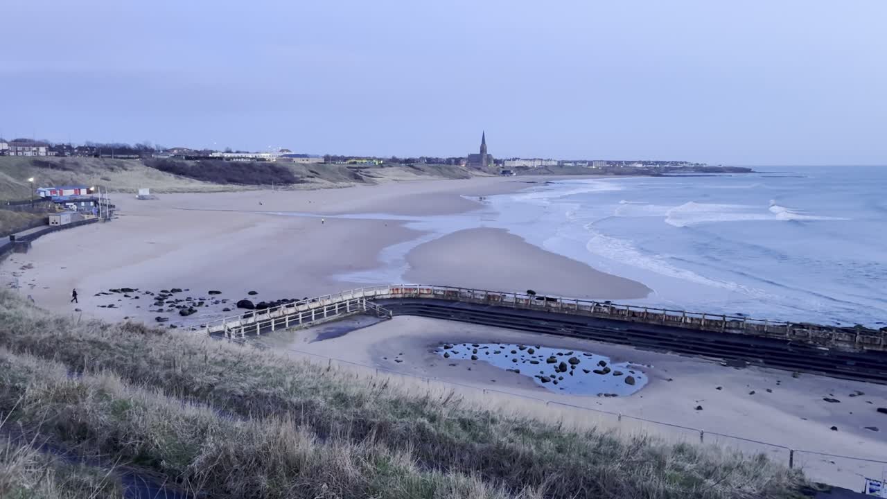 Tynemouth Longsands from the South end of the beach on a quiet spring morning before sunrise - North Tyneside, UK