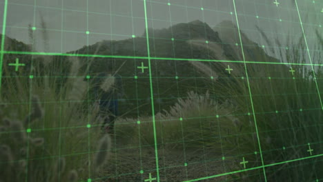 two hikers exploring mountain trail among grasses, demonstrating technology via green digital grid