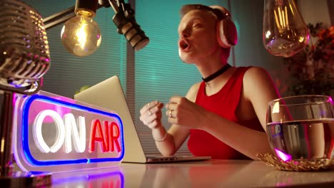 woman podcaster recording live broadcast in home studio