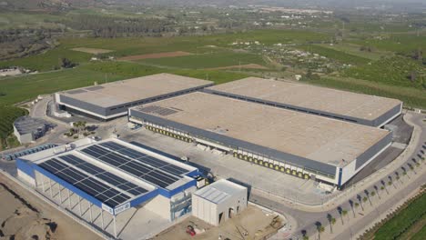 aerial-orbit-over-a-large-industrial-commercial-shipping-distribution-facility-in-farmland-of-cartama-spain