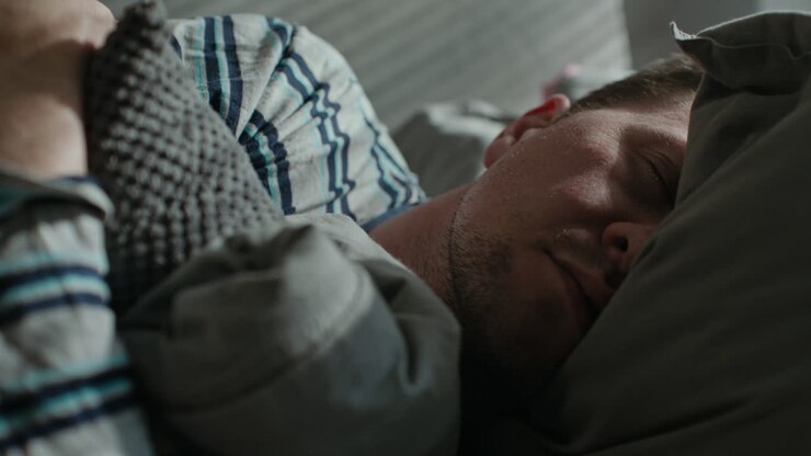 A sad man wakes up tired on his sofa