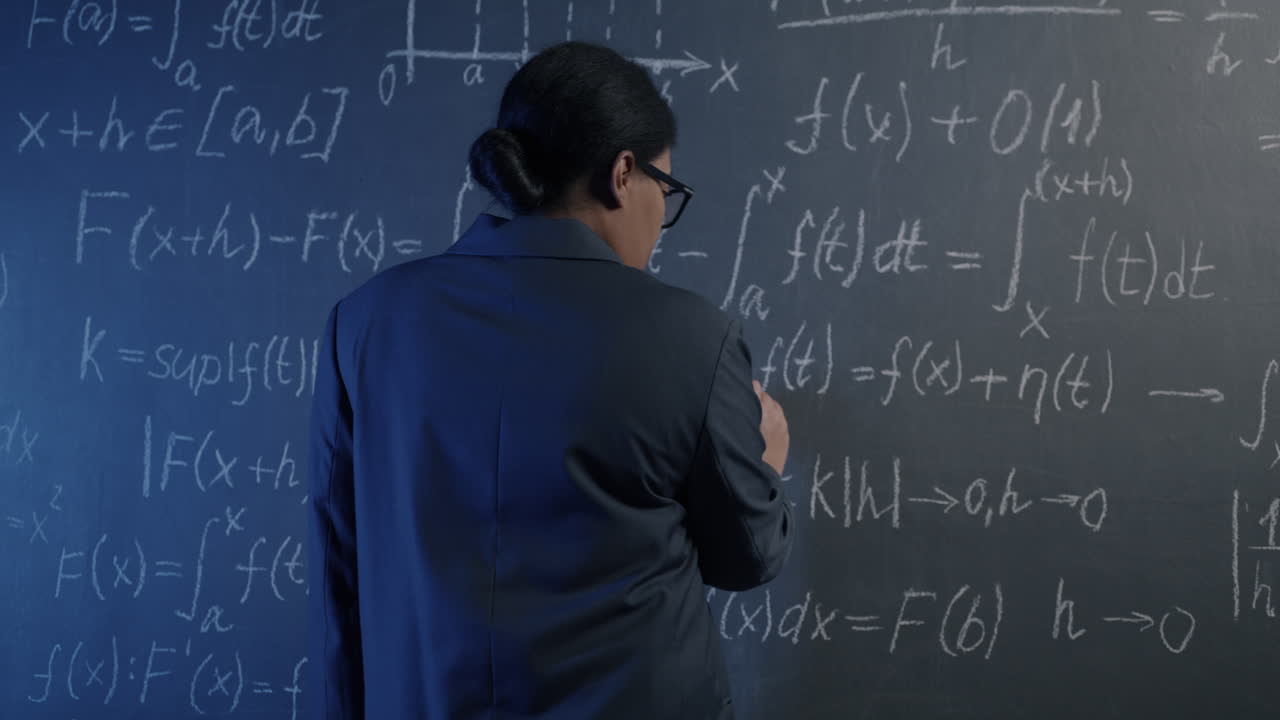 Woman explaining mathematical concepts on a blackboard