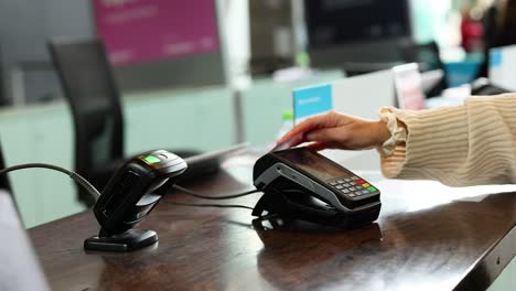 person making a contactless payment with card