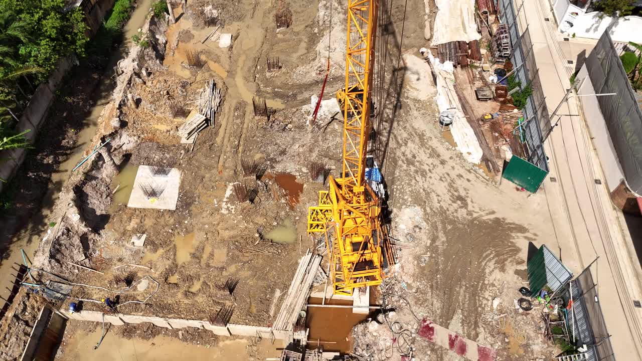Aerial view of a construction site with a large crane and excavation work