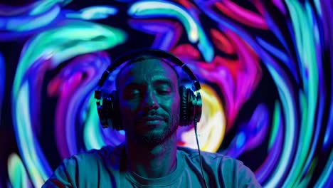 man with headphones at a nightclub