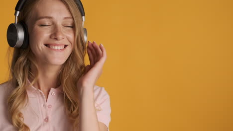 caucasian woman in headphones listening to music.