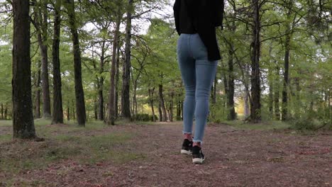 Skinny-female-model-walking-in-a-park-low-angle-shot