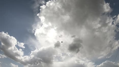 time lapse of cloudscape with bright sun shining and revealing itself behind clouds.