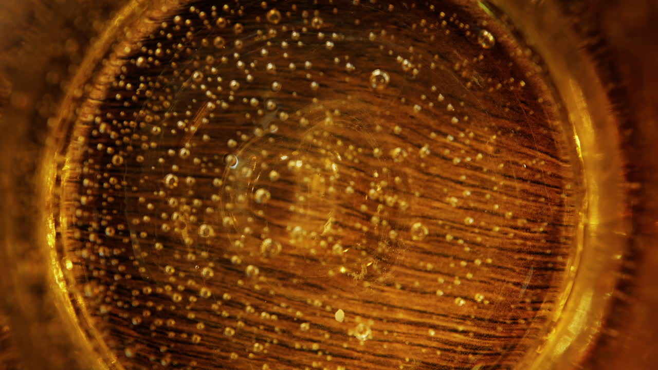 Close up of sparkling water in a yellow glass on a table at a restaurant