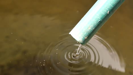 water flowing through green pipe