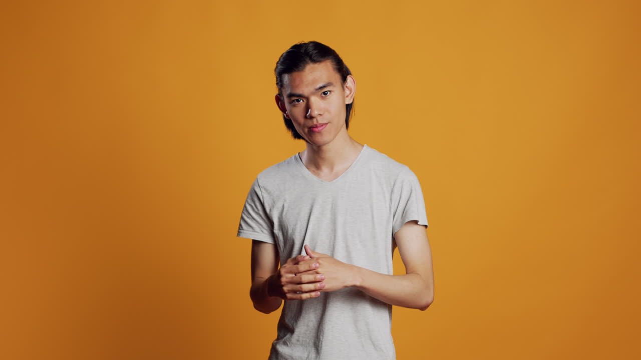 Asian man clenching fists and acting violent