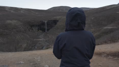 woman who just hiked up the mountains of skaftafell, iceland is watching at what she just accomplished