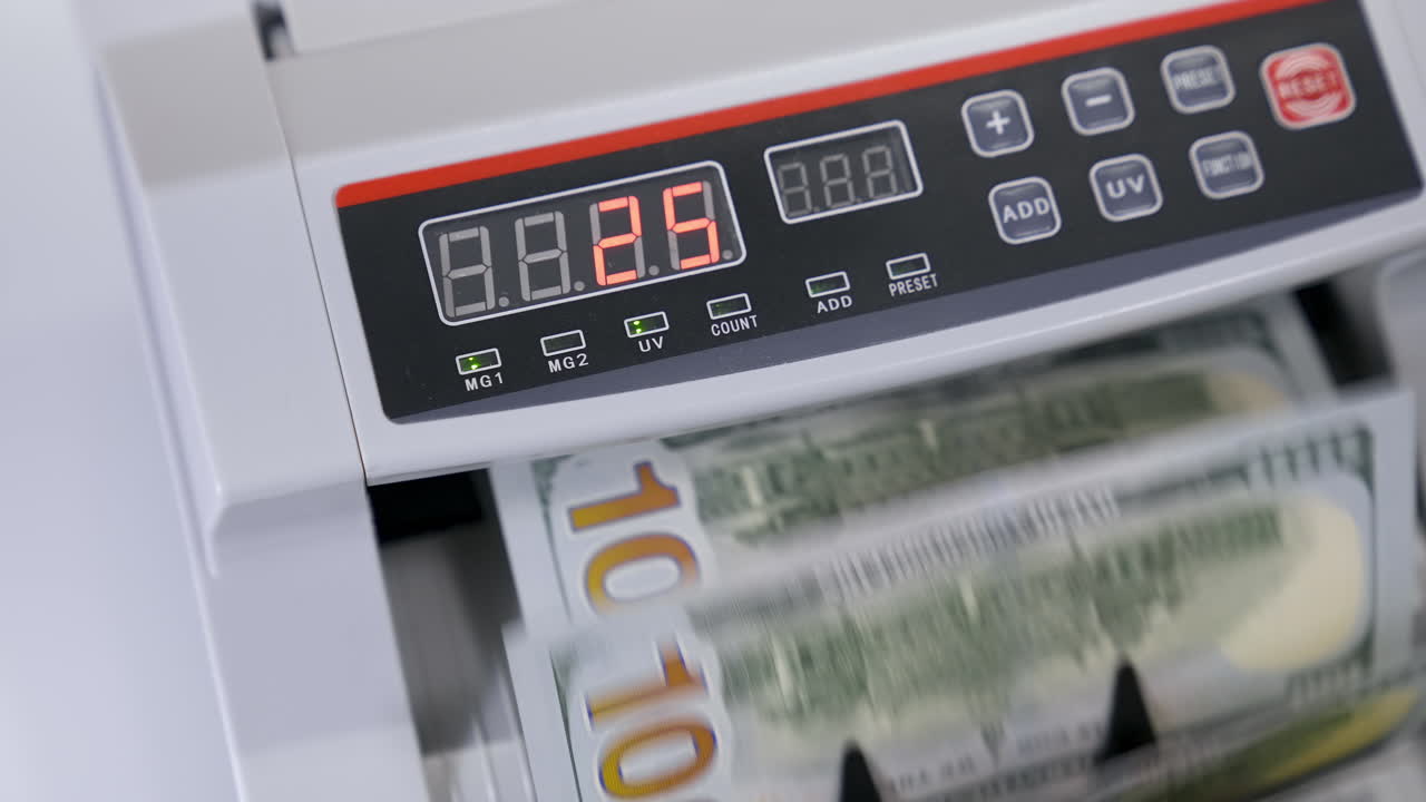 Cash money counting machine. Banknote counter are counting hundred dollar bills. Close-up
