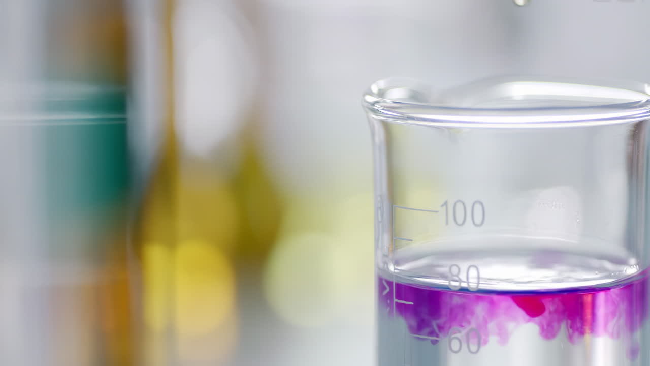 Scientists transfer pink solution chemical or test sample in beaker tissue culture flask with Suction Pipette with Suction Pipette for cell culture assay in biological cabinet biotechnology laboratory