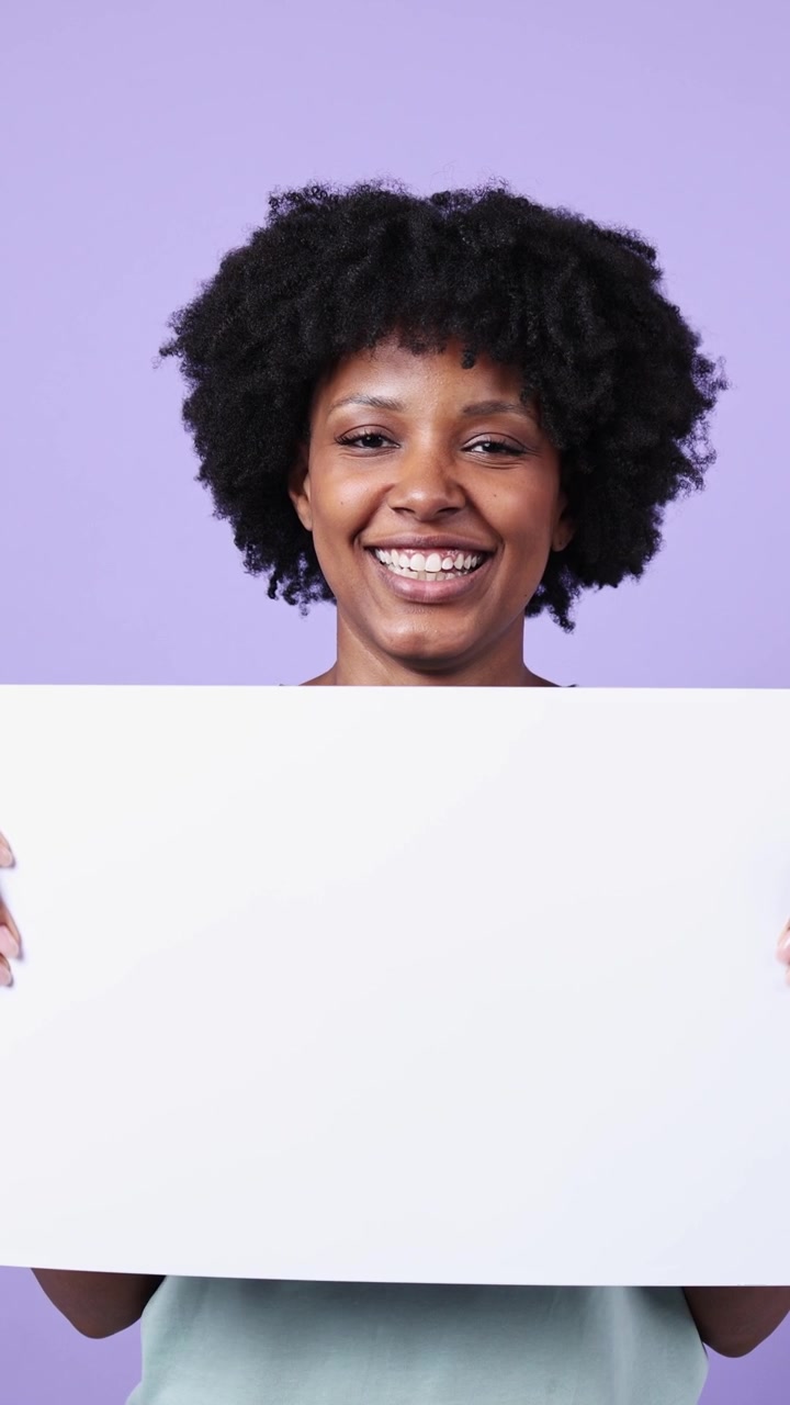 Happy African American Woman Holding Blank Sign on Purple Background