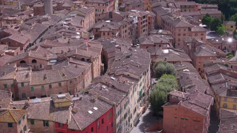 Aerial drone view of old buildings in Tuscany, Italy, on a cloudy day.