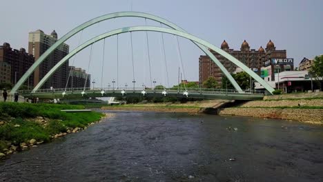 bridge in taoyuan taiwan with city skyline in background