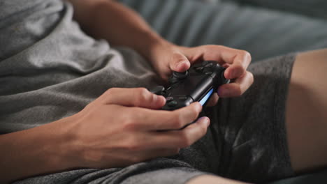 teenager playing video games on couch