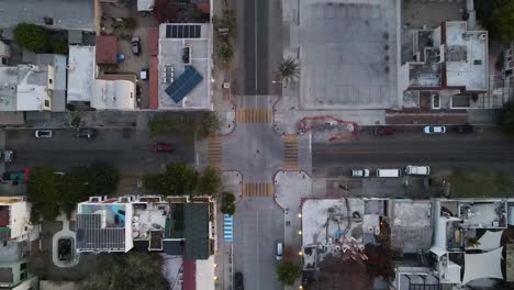 aerial: top down view of quiet crossroad junction in mexican city la paz