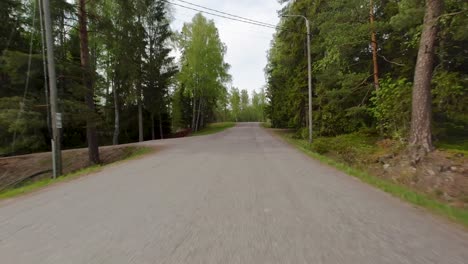 Conduciendo-Por-Una-Tranquila-Carretera-Rural-Flanqueada-Por-Hermosos-árboles-En-La-Campiña-Finlandesa