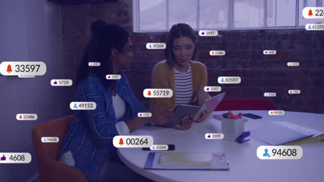 animation of social media icons with numbers over diverse colleagues discussing work in office