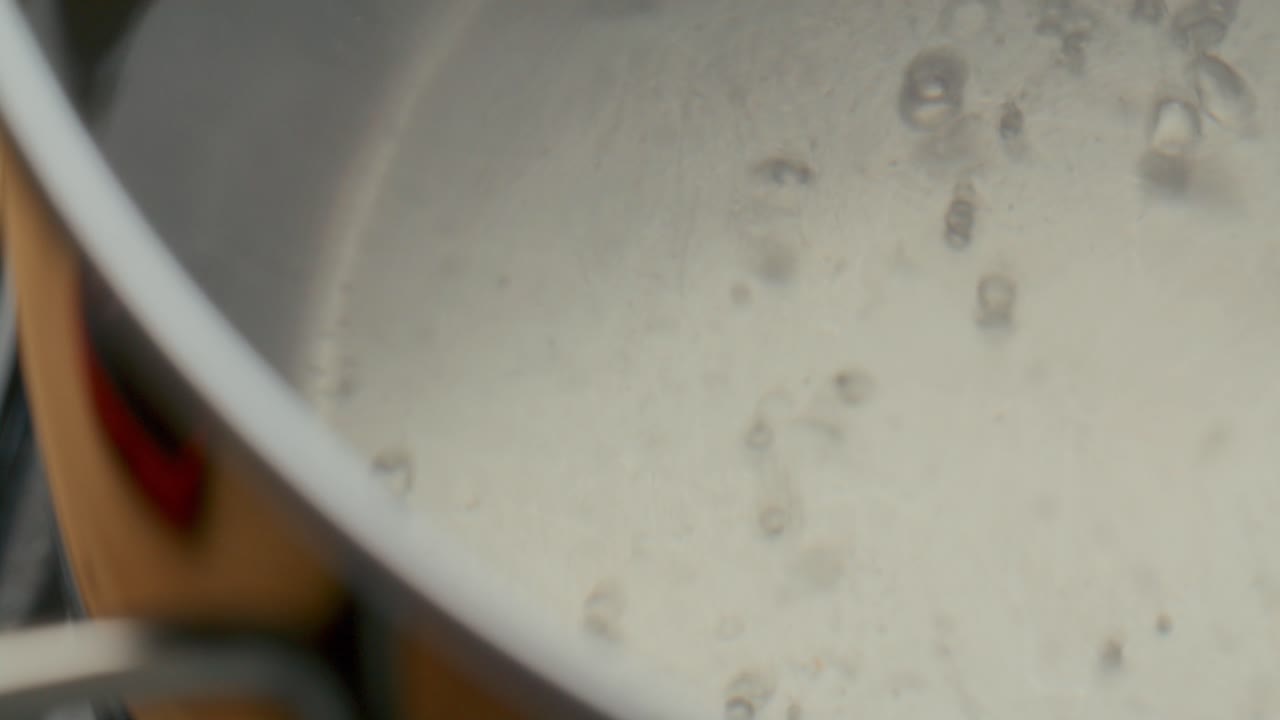 Extreme Close-Up of Water Boiling in Steel Pot