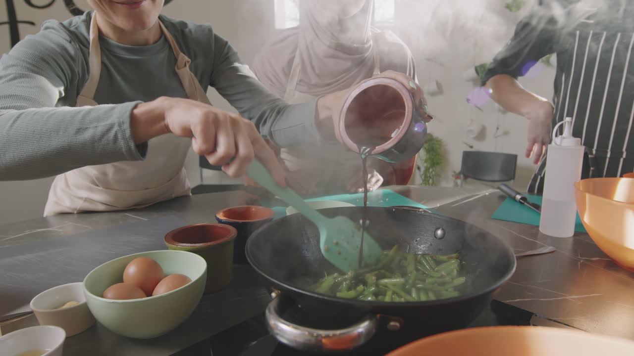 Adding Sauce To Green Beans In Frying Pan