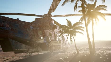 old rusted military helicopter in the desert at sunset