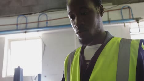 Close up view of worker using tablet computer in factory