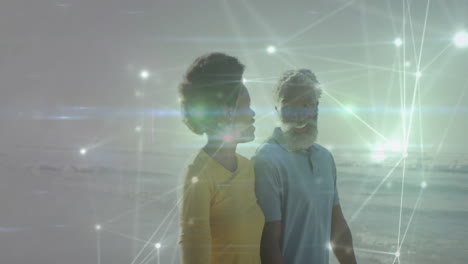 man and woman walking along sandy shoreline, showing digital technology network with glowing nodes