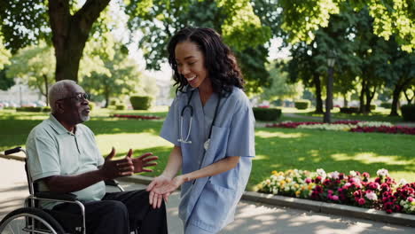 nurse assisting elderly patient in wheelchair in park