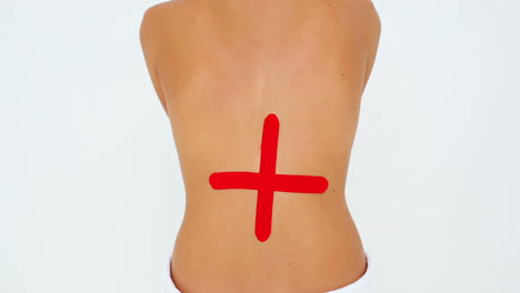 woman having red kinesio tape applied to back