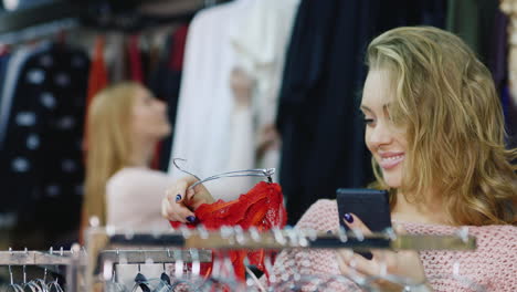 young woman chooses chothes in women's clothing store 1