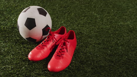 animation of football and red shoes over grass with copy space