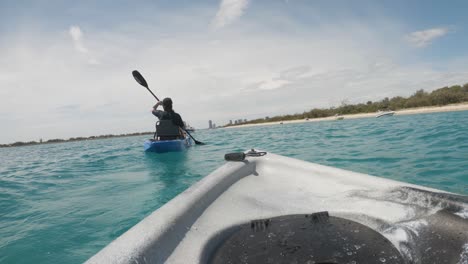 vista en primera persona de una pareja en kayak en el océano en un popular lugar de vacaciones