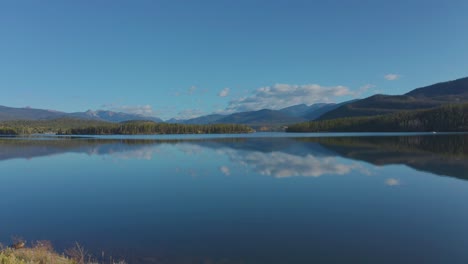 early morning aerial footage in shadow mountain lake in grand lake colorado with the fall colors just beginning