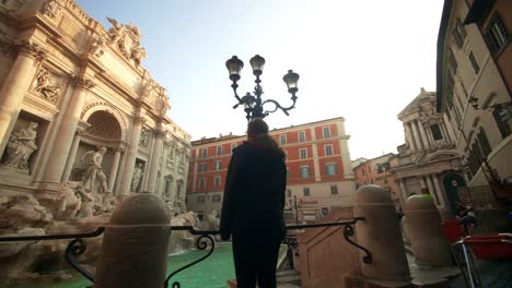 woman looking at trevi fountain