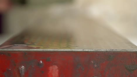 a macro shot of whetstone being washed with a sponge in slow motion