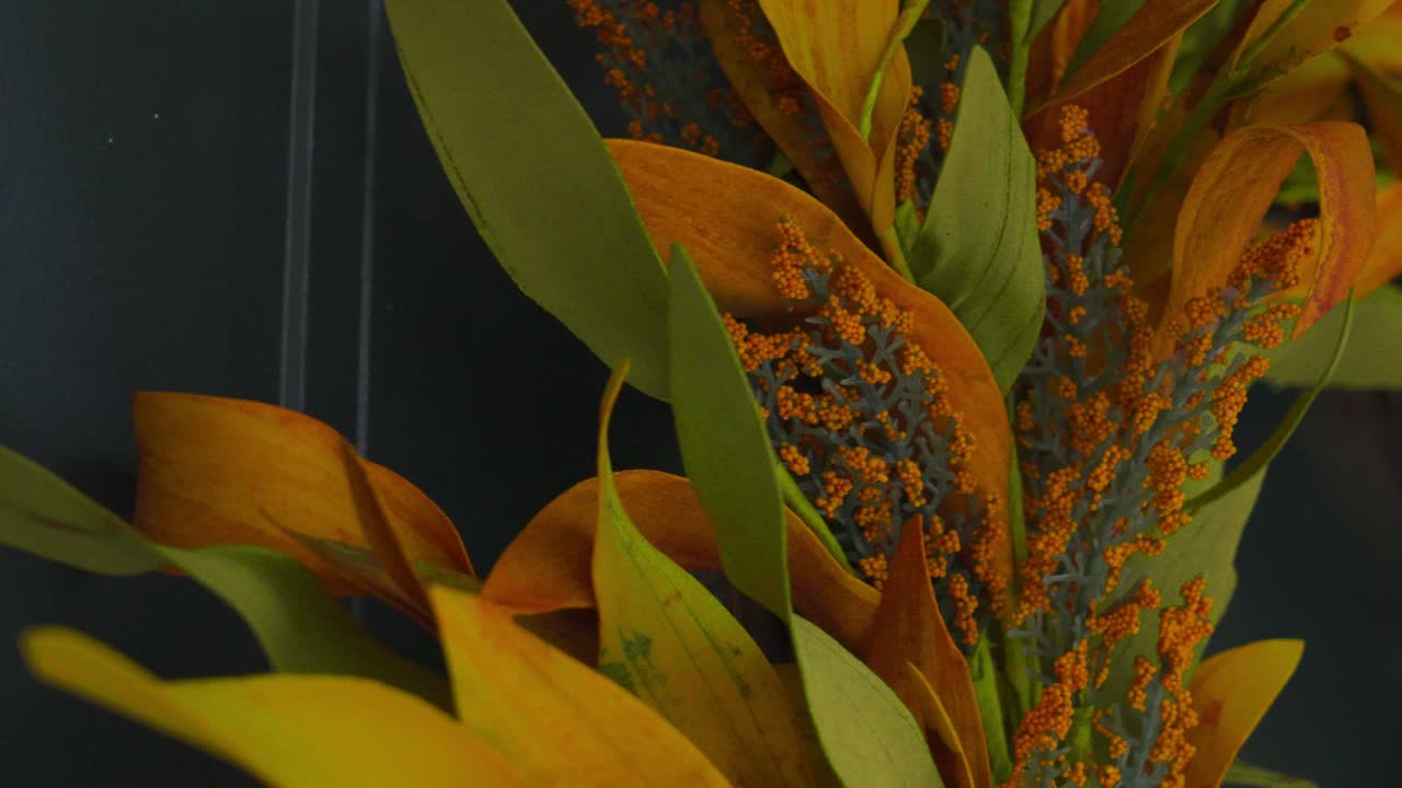 Extreme close up on a wreath made off fake autumn plants