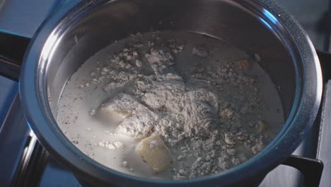 Adding-And-Mixing-Flour-To-Pasta-Cheese-Sauce-Being-Cooked-In-A-Pot