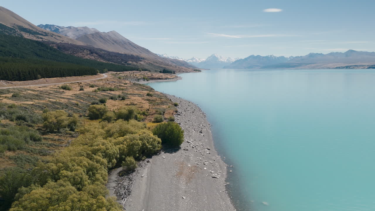 Aerial view of a beautiful turquoise lake in New Zealand, surrounded by mountains