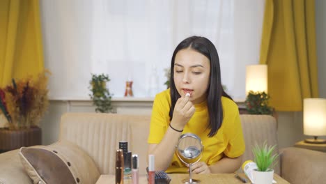 Young-woman-applying-lipstick.
