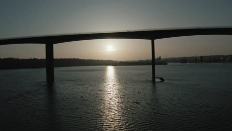 flying underneath a big bridge