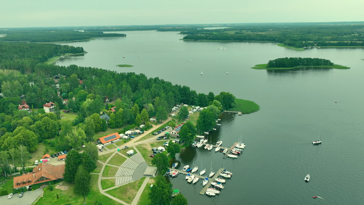 Aerial View of a Calm Lake with Marina and Sailboats