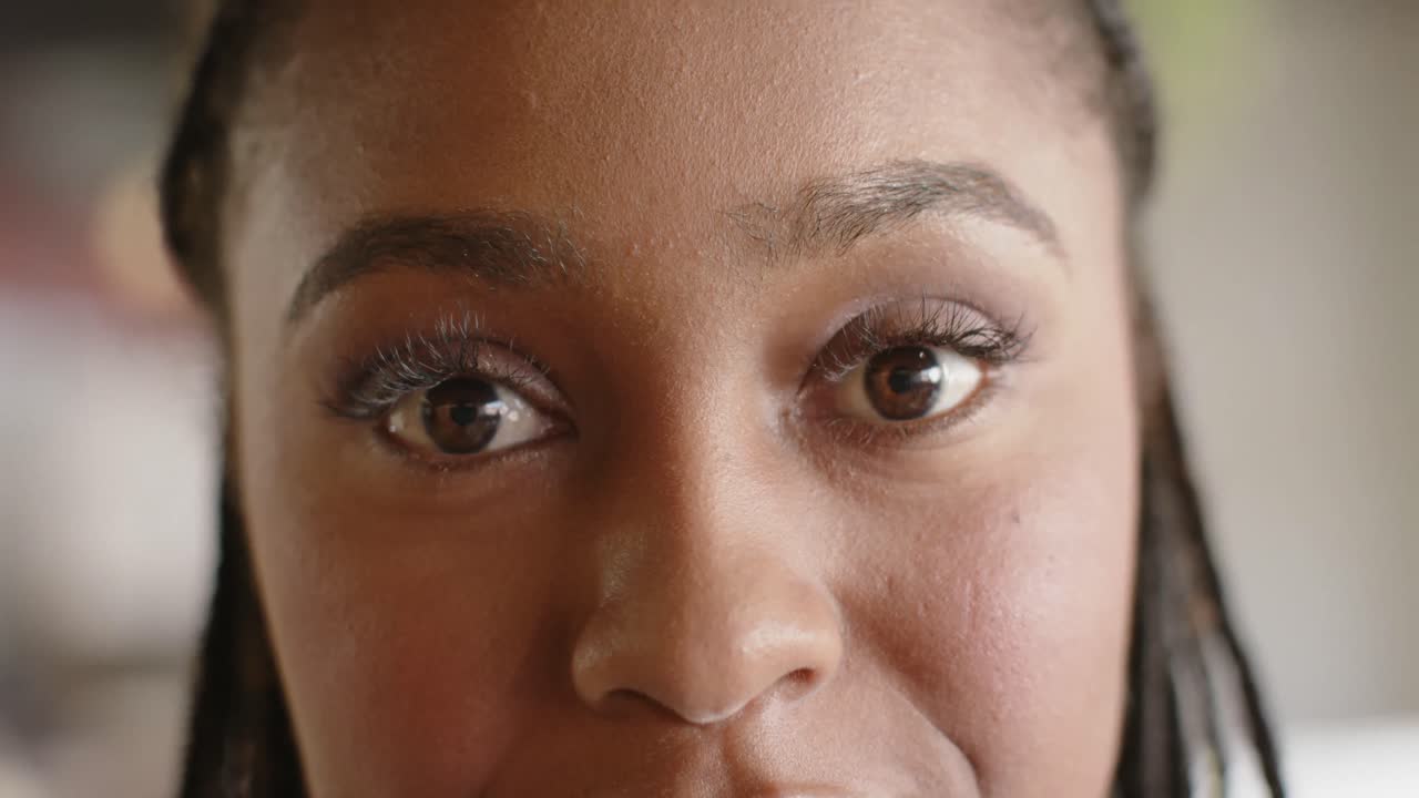 Portrait of close up happy african american businesswoman smiling at office, slow motion