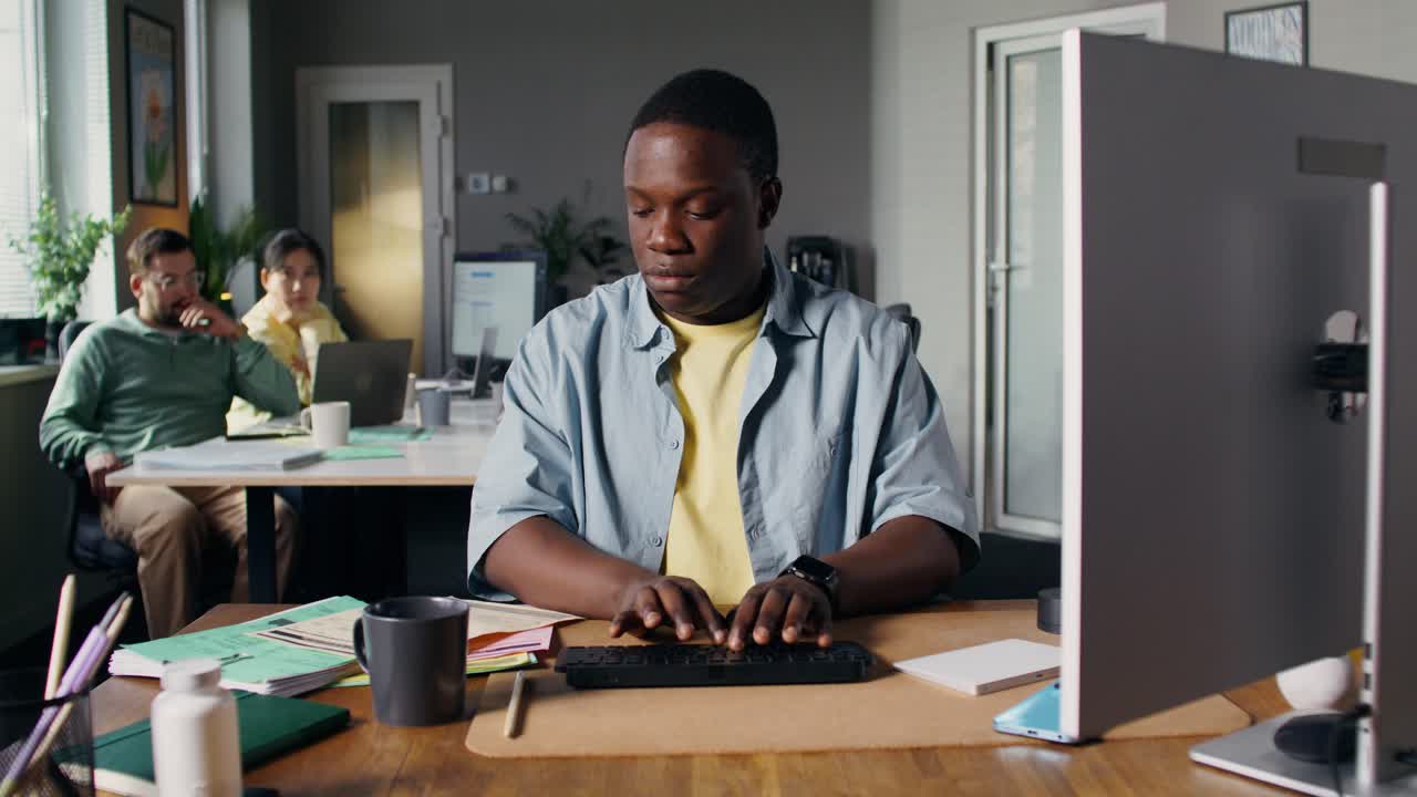 Man Working on Computer in an Office