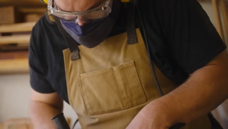 close up of carpenter cutting metal with angle grinder making sparks