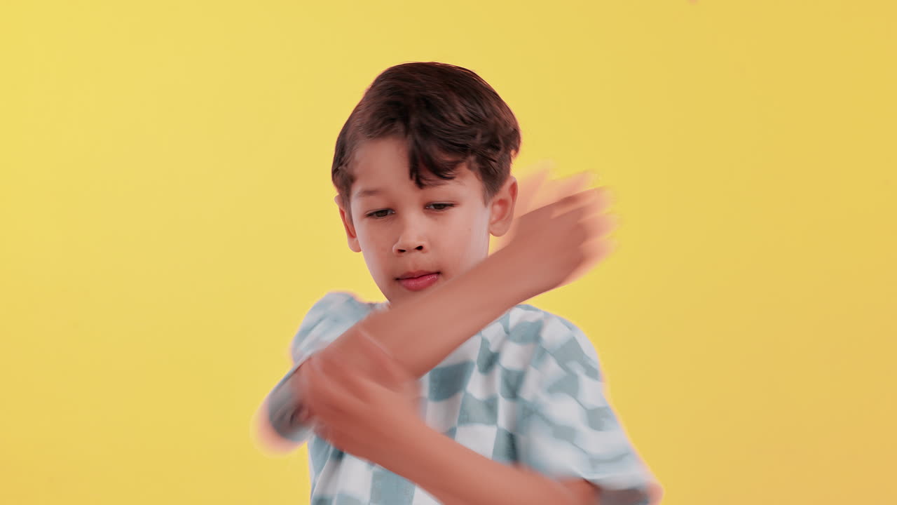 A young boy with arms crossed