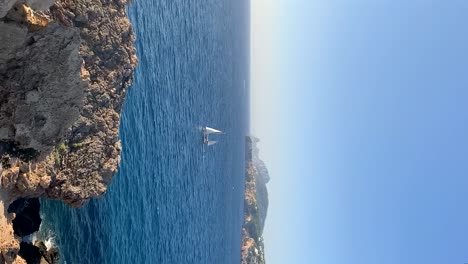 pan - boat anchoring in a cove in ibiza